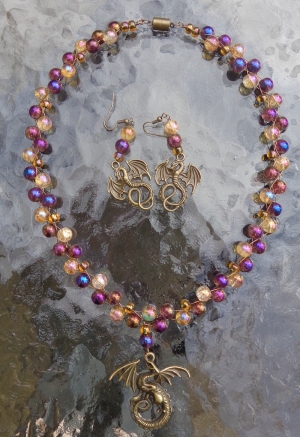 Dragon necklace made with gold and purple beads by Deborah Cooke